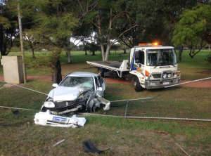 Car crashed into a fence and Swan Towing's emergency tilt tray is ready to tow the car away from the accident scene.
