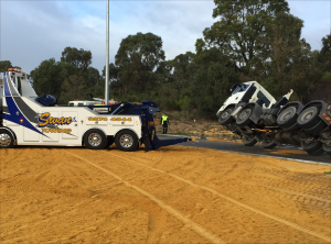 Swan Towing's heavy recovery vehicle attending to a truck rollover.